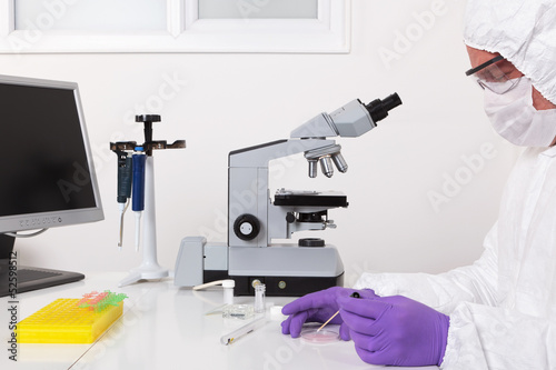 Photo: Lab technician taking a sample Lab technician taking a sample