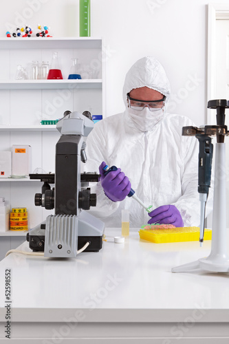 Photo: Lab technician using a pipette Lab technician using a pipette