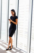 Photo: Businesswoman Using Mobile Phone In Office Businesswoman Using Mobile Phone In Office