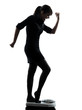 Photo: woman standing on weight scale happy silhouette woman standing on weight scale happy silhouette