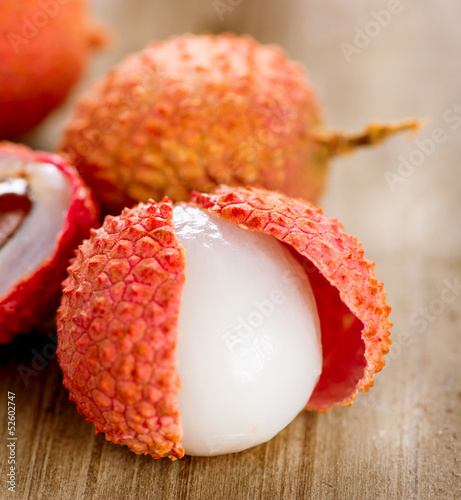 Photo: Lychee on a wooden table. Lichi Closeup. Selective focus Lychee on a wooden table. Lichi Closeup. Selective focus