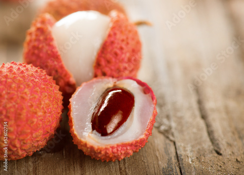 Photo: Lychee on a wooden table. Lichi Closeup. Selective focus Lychee on a wooden table. Lichi Closeup. Selective focus