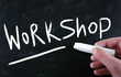 "Workshop" handwritten with white chalk on a blackboard