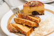 Caramel cake slices on white plate, closeup