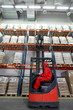 Photo: Worker loading sacks with forklift loader in warehouse Worker loading sacks with forklift loader in warehouse