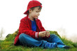 Cute child sitting at riverside
