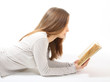 Lying girl with a book on white background