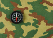 Compass on a camouflage background
