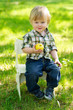 Kid eating an apple in the garden