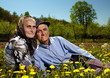 Photo: Old couple sitting in a dandelion field Old couple sitting in a dandelion field