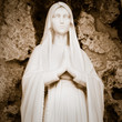 Photo: Young virgin praying with a rosary hanging from her arms Young virgin praying with a rosary hanging from her arms