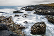 Calm sea in the sunset surrounded by basalt stones