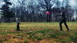 Father and son playing football in the park, slow motion