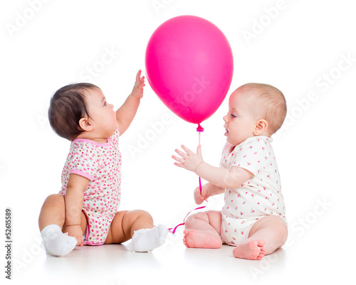 Photo: babies girls play red ballon isolated on white babies girls play red ballon isolated on white