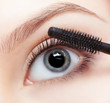 beautiful woman applying mascara