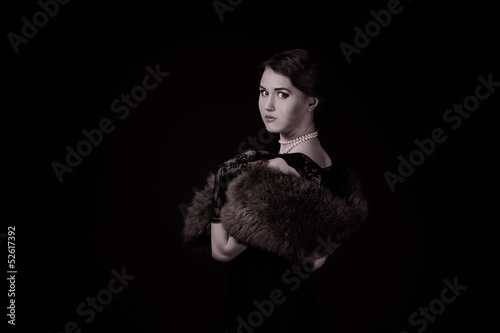 Photo: The girl in the retro image of a black background The girl in the retro image of a black background