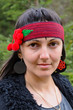 Photo: Pretty hippie woman outdoors wearing a headband Pretty hippie woman outdoors wearing a headband
