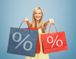 woman holding shopping bags with percent sign