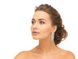 woman wearing shiny diamond earrings
