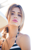 model with surfboard on the beach