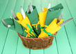 Forks and knives wrapped in green and yellow paper napkins,