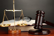Wooden gavel, golden scales of justice  and books