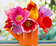 Beautiful tulips in bouquet on table on bright background