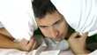 Man trying to sleep with a pillow over his head