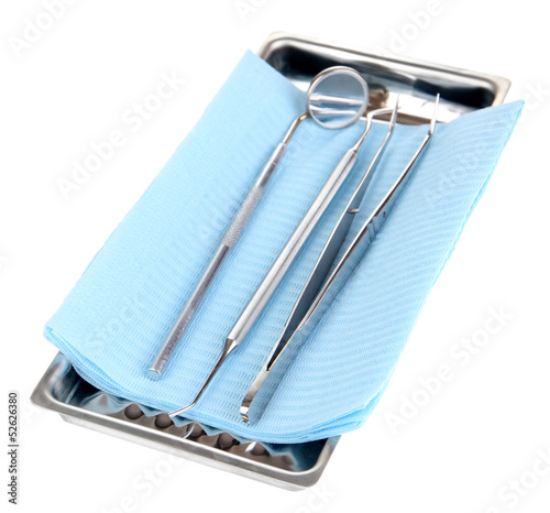 Photo: Dentist tools isolated on white Dentist tools isolated on white