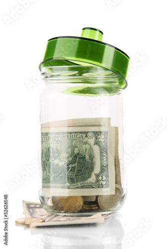 Photo: Glass jar with money isolated on white Glass jar with money isolated on white