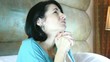 Beautiful woman praying on the bedroom