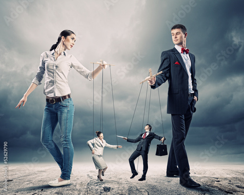Photo: Businesspeople with marionettes Businesspeople with marionettes