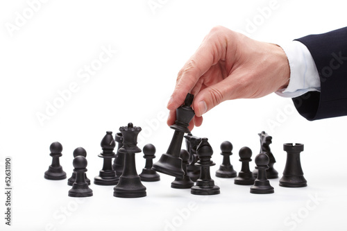 Photo: Business man moving chess figure Business man moving chess figure
