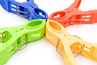colorful clothespins line up on white