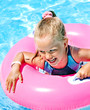 Child  on inflatable in swimming pool.