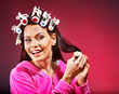 Woman wear hair curlers on head.