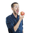 Cheerful beautiful man eating apple, isolated over white backgro
