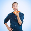 portrait of a young beautiful man eating a slice of pizza marghe