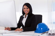 Happy Female Architect Using Computer