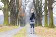 woman wearing rubber boots in autumnal alley