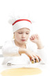 Photo: little girl cutting cookies little girl cutting cookies