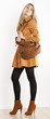 standing woman wearing coat and fashionable brown shoes with a h