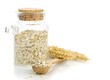 A jar of oatmeal flakes and wheat on a white background
