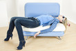 woman wearing blue clothes lying on sofa