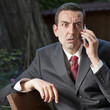 amazed businessman receiving strucking news