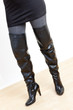 Photo: detail of standing woman wearing fashionable black boots detail of standing woman wearing fashionable black boots
