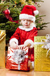 Photo: little girl as Santa Claus with Christmas presents little girl as Santa Claus with Christmas presents