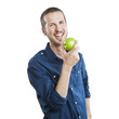 Cheerful beautiful man eating apple, isolated over white backgro