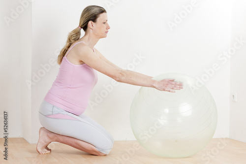 Photo: pregnant woman doing exercises with a ball pregnant woman doing exercises with a ball