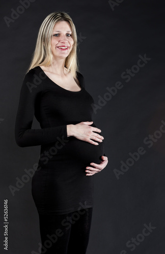Photo: portrait of pregnant woman wearing black clothes portrait of pregnant woman wearing black clothes